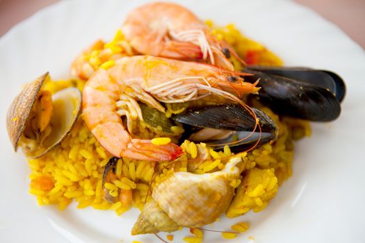 Plate with traditional Spanish paella dinner in closeup