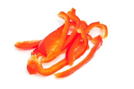 slices of red paprika over white background