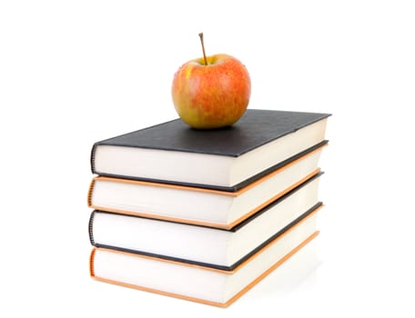 back to school: stack of books with apple on top over white background
