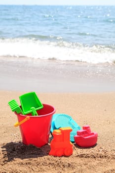 colorful plastic toys at the beach near the ocean