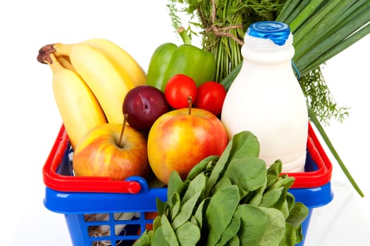 Shopping basket in closeup filled with healthy grocery over white background