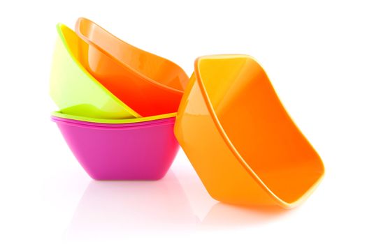 stack of colorful empty snack bowls over white background