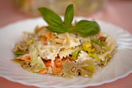 plate with colored farfalle pasta food in closeup