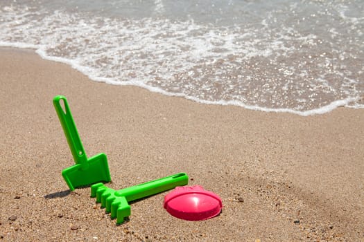 plastic colorful toys at the beach near the ocean