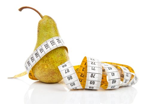 healthy diet; pear with measure tape over white background