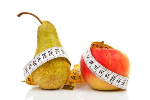 healthy diet; pear and apple with measure tape over white background