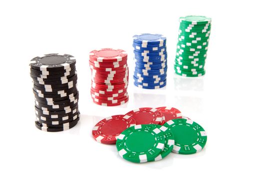 stacks of colorful poker casino chips over white background