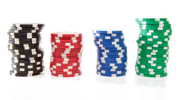 stacks of colorful poker casino chips over white background