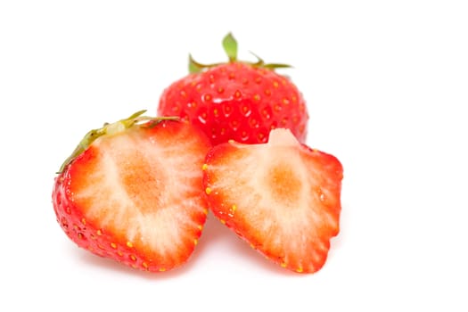 whole and halve fresh strawberries over white background
