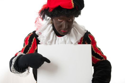 Zwarte piet ( black pete) typical Dutch character part of a traditional event celebrating the birthday of Sinterklaas in december over white background is holding empty text board