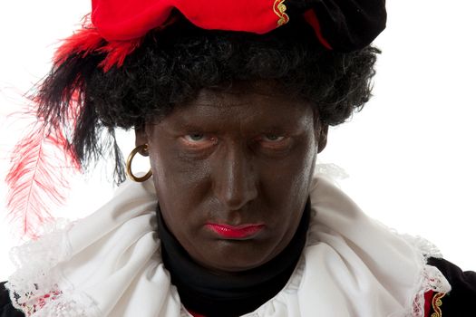 Zwarte piet ( black pete) typical Dutch character part of a traditional event celebrating the birthday of Sinterklaas in december in closeup looking angry