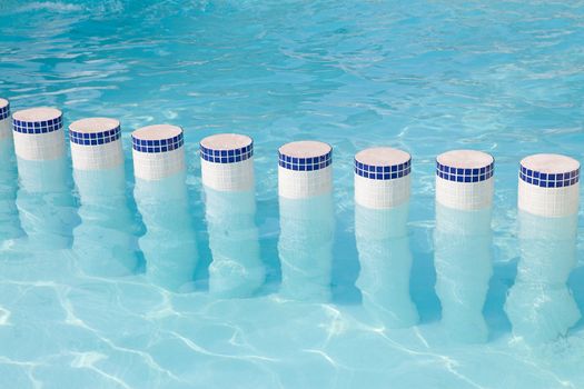 poles in the water of a swimming pool