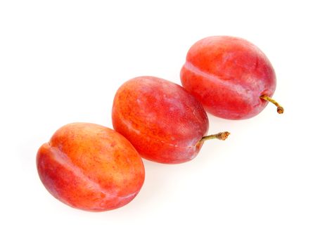 couple of plums in closeup over white background