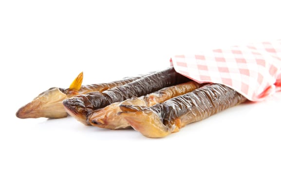 pile of Dutch smoked eel under napkin isolated on white background