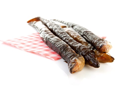 pile of Dutch smoked eel on napkin isolated on white background