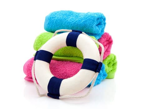 colorful towels and life buoy over white background