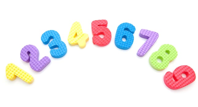 colorful foam figures one to nine over white background