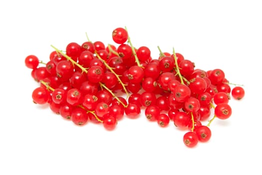 pile berries of red currant in closeup over white background