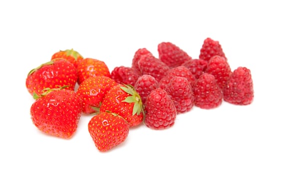 fresh raspberries and strawberries over white background