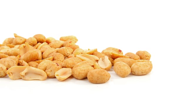 salted peanuts in closeup over white background