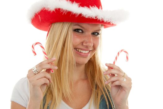 portrait of blonde christmas girl with hat and candy over white background