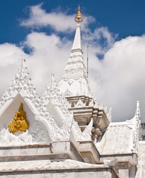 Buddhist temples in Thailand. The top of the roof is decorated with white stucco.