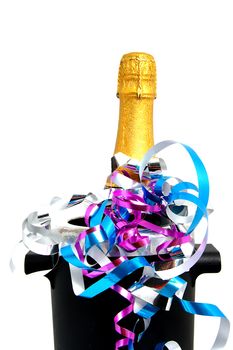 Neck of closed champagne bottle packed in golden paper witk cooler and party streamers over white background