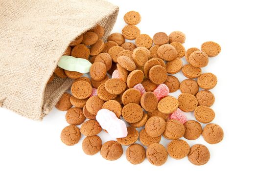 bag with typical dutch sweets: pepernoten (ginger nuts) for a celebration at 5 december in the Netherlands over white background