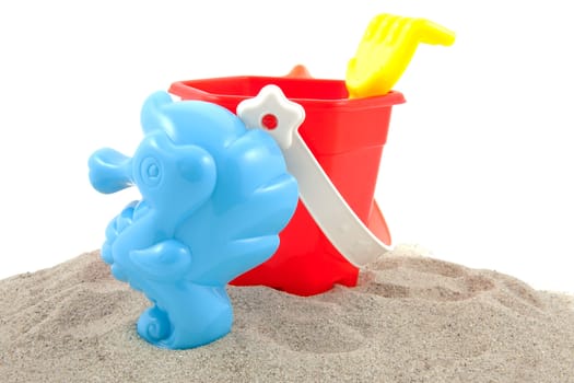 colorful plastic play toys for the bach over white background