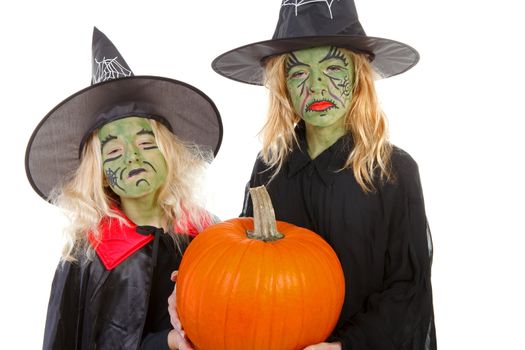 Scary green witches for Halloween with pumpkin over white background