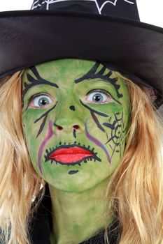 Portrait of green Halloween witch girl in closeup