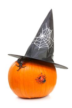 big pumpkin with black witch hat and spiders for halloween isolated on white background
