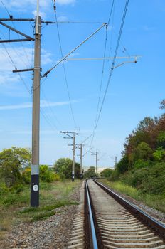 Railway track  cutting through rural countryside in summer