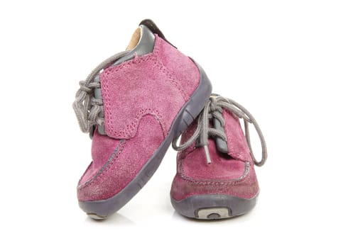 pair of purple children's shoes worn over white background