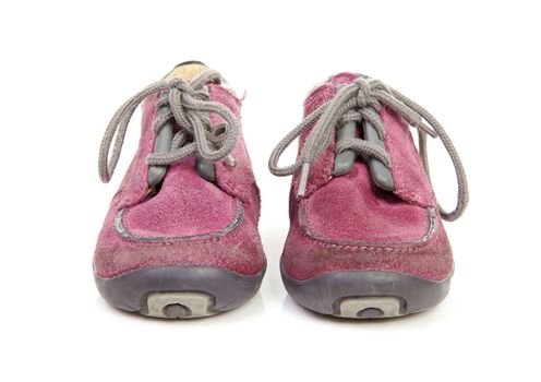 pair of purple children's shoes worn over white background