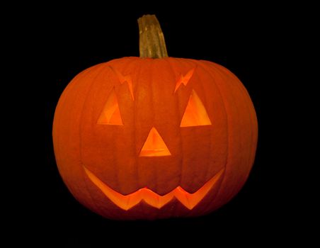 scary halloween pumpkin with face isolated on black background