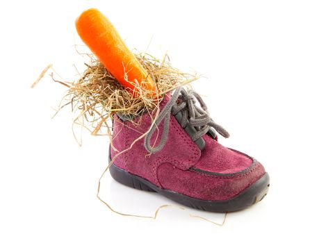 purple little children's shoe with carrot, traditional for Sinterklaas in the Netherlands over white background