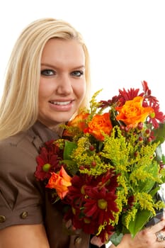 Young blonde woman with beautiful bouquet of flowers over white background