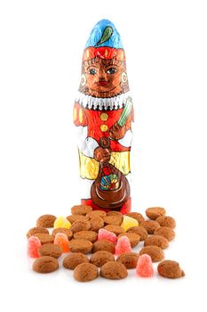 Typical dutch sweets: pepernoten (ginger nuts) and chocolate black pete ( zwarte piet) for celebration at 5 december in the Netherlands over white background