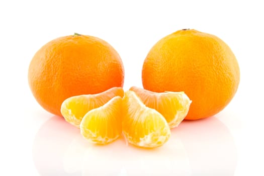 Two whole tangerines and couple of slices isolated on white background