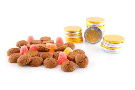 Typical dutch sweets: pepernoten (ginger nuts) and chocolate money for a celebration at 5 december in the Netherlands over white background