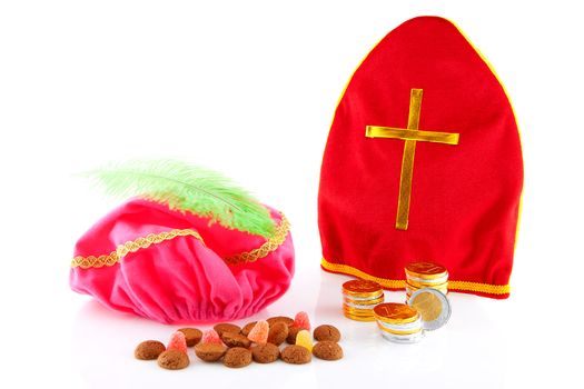 Mitre of sinterklaas and hat of zwarte piet ( black pete) with dutch candy over white background