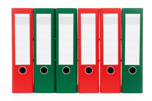 red and green ring binders in a row on white background