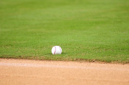 baseball lying on grass in field