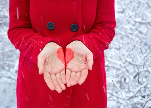 Young woman with heart in her hand