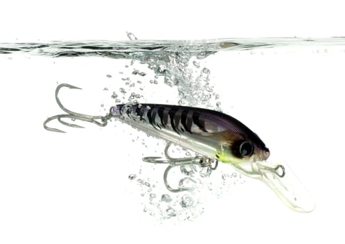 gray and black lure making a splash in water on white background