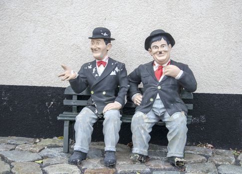 funny Laurel and hardy on a bench in garden