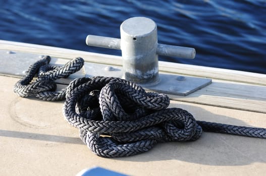 cleat and rope on dock with water in background