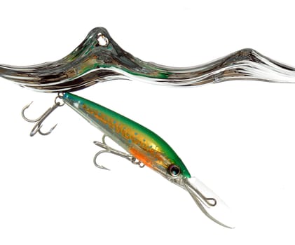 green and orange lure or fishing bait making a splash in water on white background