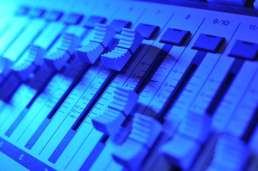 Mixing console illuminated by blue light